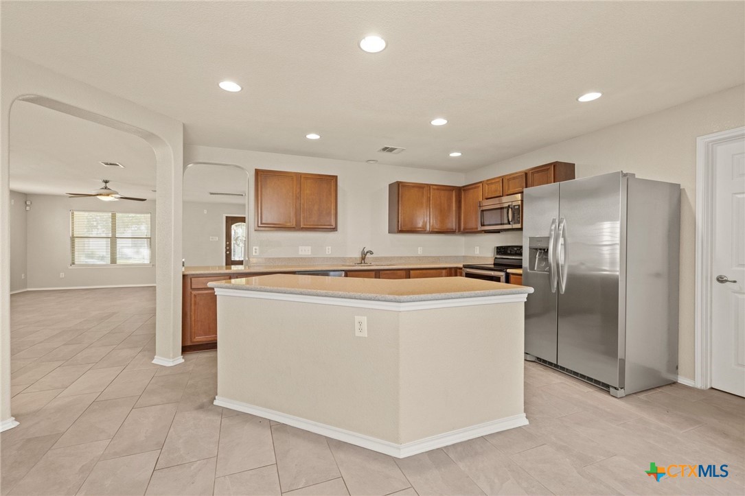 8420 Starview Street Temple, TX 76502 - Photo 16 of 36 a large kitchen with stainless steel appliances granite countertop a refrigerator a sink a stove and a refrigerator