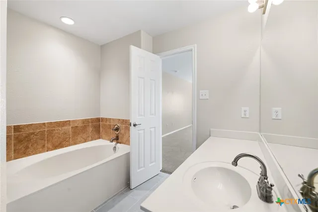 a bathroom with a bathtub and a sink