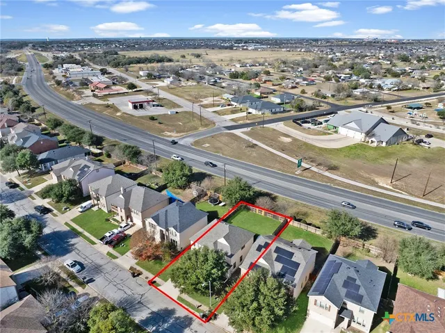 an aerial view of residential houses with outdoor space