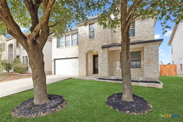a front view of a house with a yard