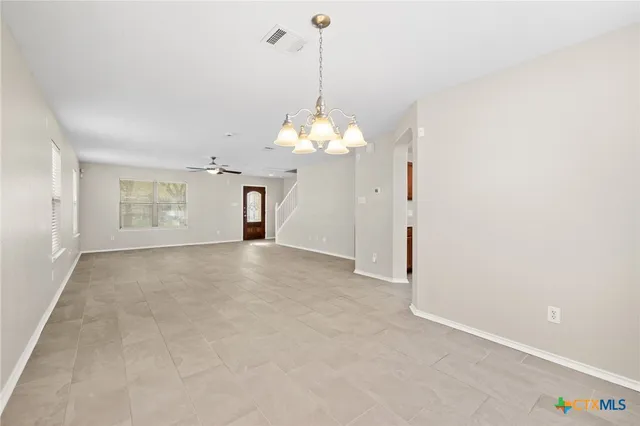 a view of a room with chandelier and windows