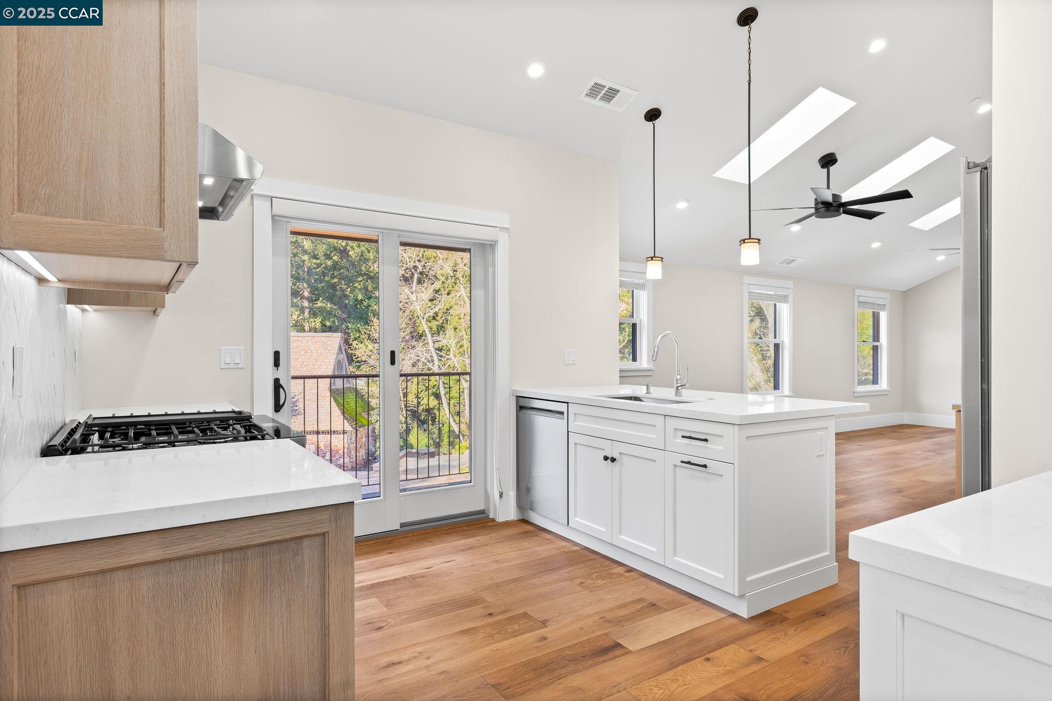 100 B Moraga Way Orinda, CA 94563 - Photo 23 of 48 a kitchen with a stove a sink a center island and a window