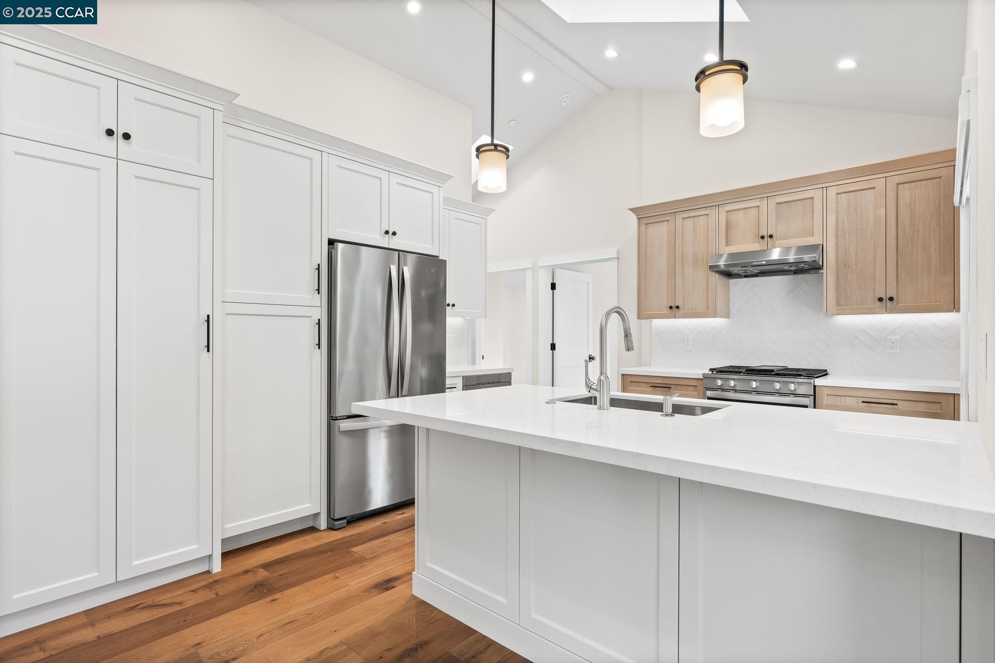100 B Moraga Way Orinda, CA 94563 - Photo 28 of 48 a kitchen with stainless steel appliances a stove a refrigerator and cabinets