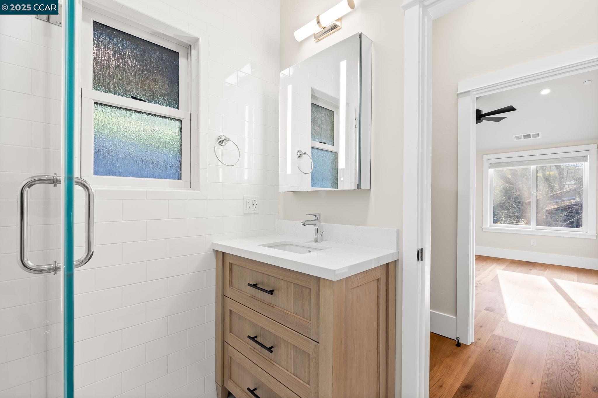 100 B Moraga Way Orinda, CA 94563 - Photo 30 of 48 a bathroom with a sink a mirror and a shower