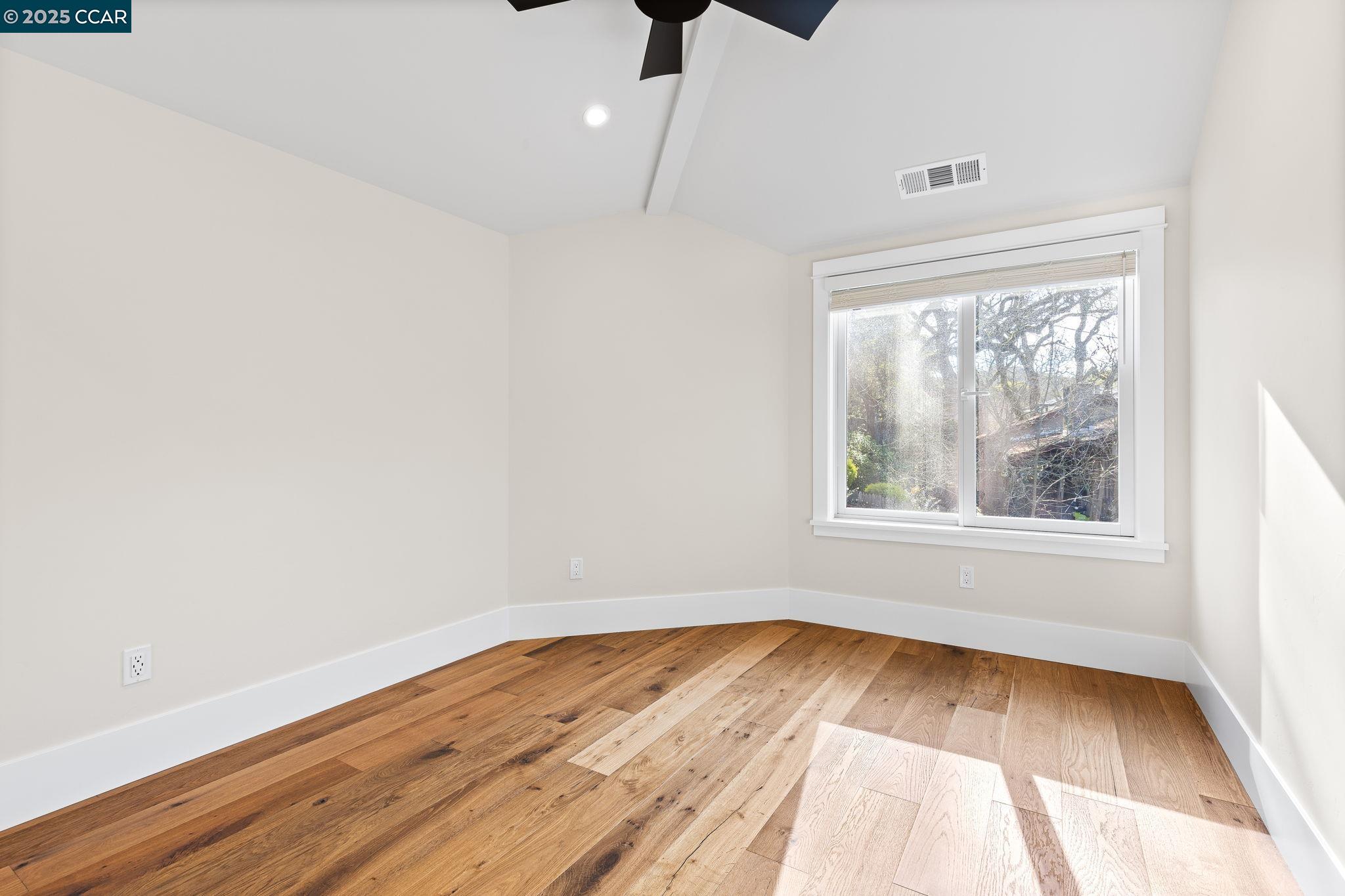 100 B Moraga Way Orinda, CA 94563 - Photo 39 of 48 an empty room with wooden floor and windows