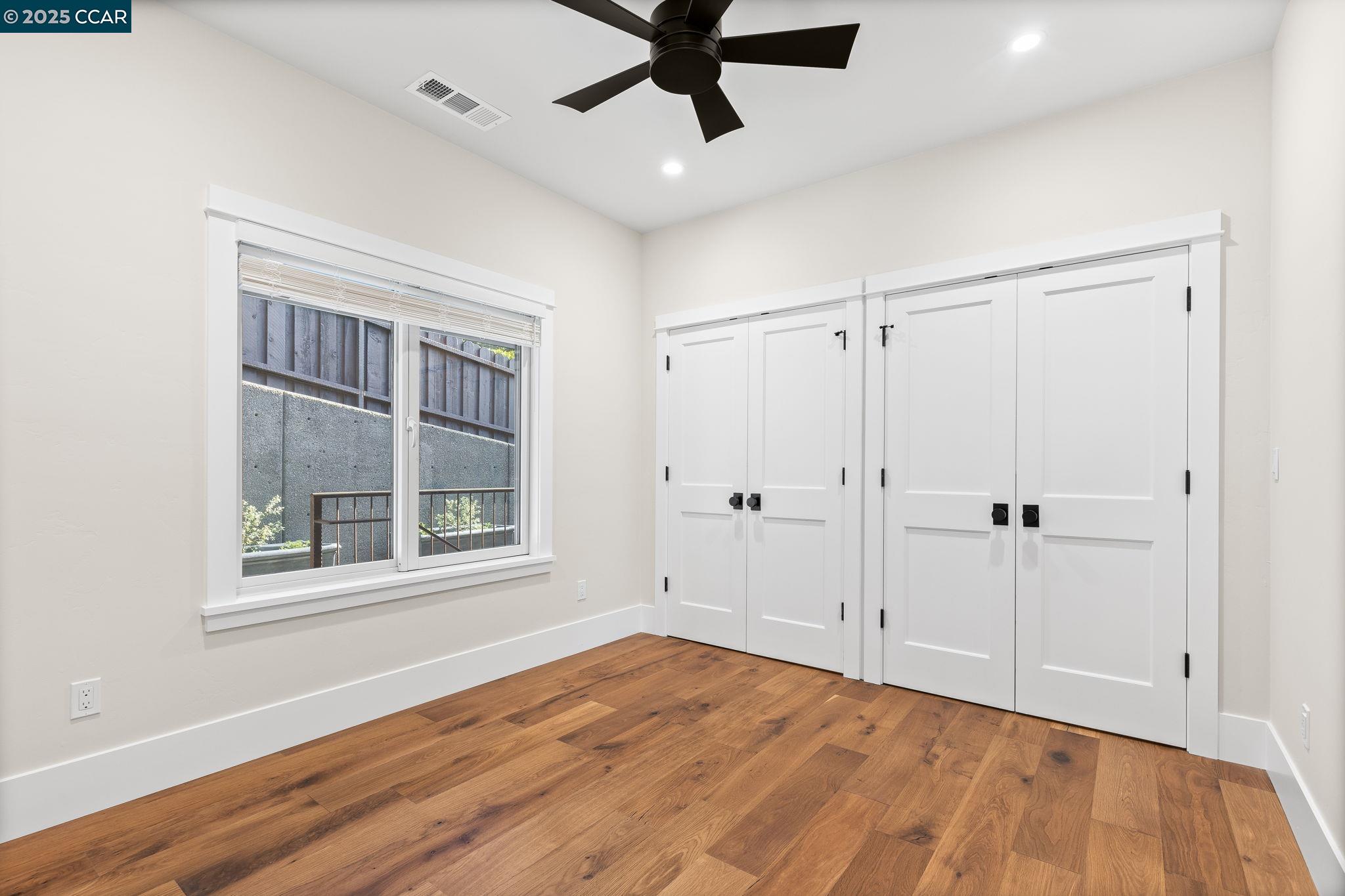 100 B Moraga Way Orinda, CA 94563 - Photo 42 of 48 a view of an empty room with a window and wooden floor