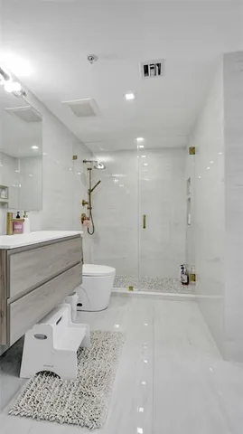 a bathroom with a toilet sink and shower