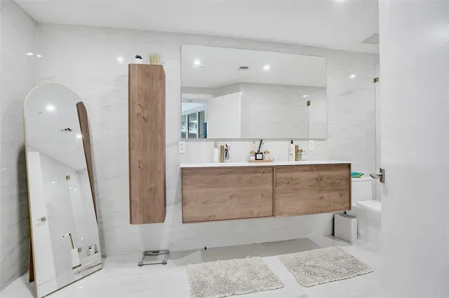 a bathroom with a sink a mirror and shower