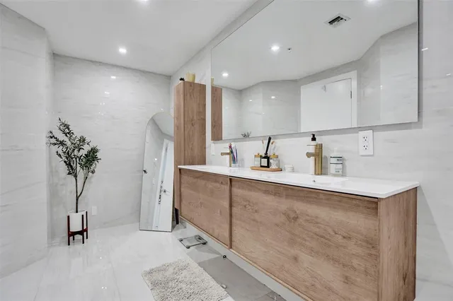 a spacious bathroom with a sink and a mirror