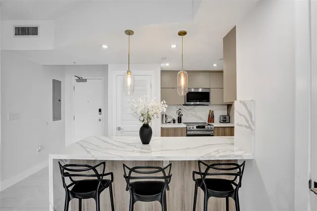 a kitchen with a table and chairs in it