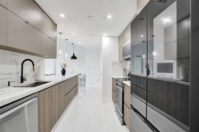 a kitchen with stainless steel appliances granite countertop a sink and cabinets