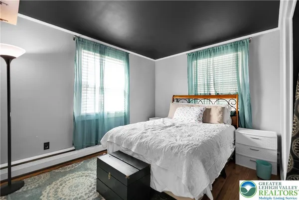 a bed sitting in a bedroom next to a window