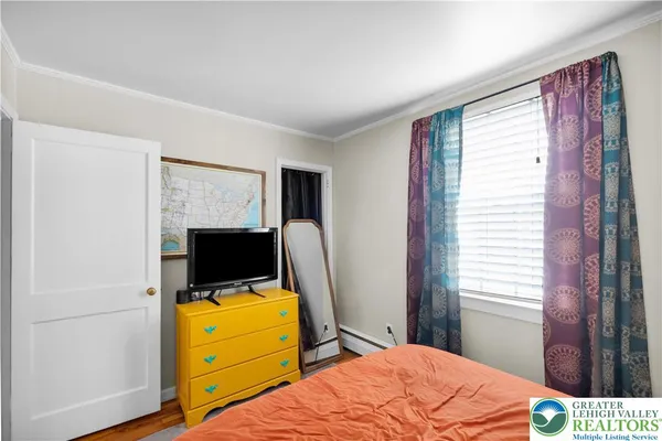 a bedroom with a bed and flat screen tv