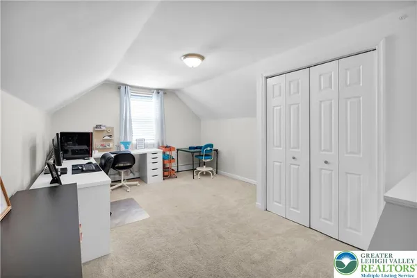 a view of a livingroom with furniture and a flat screen tv