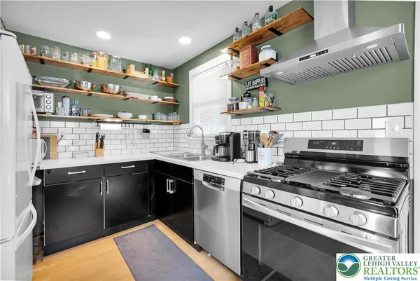 a kitchen with stainless steel appliances granite countertop a stove and a sink