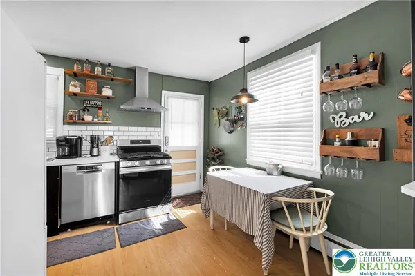 a kitchen with a sink cabinets and dining table