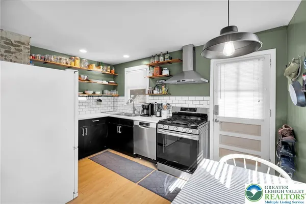 a kitchen with stainless steel appliances granite countertop a stove sink and cabinets