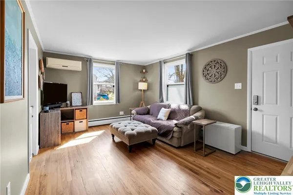 a living room with furniture and a flat screen tv