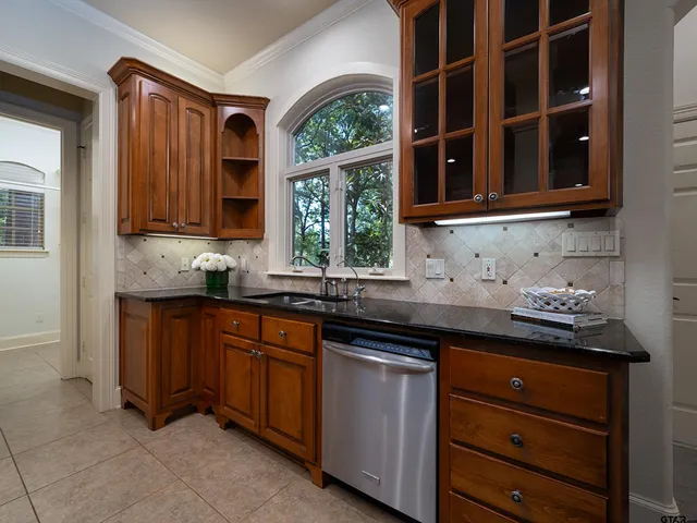 a kitchen with granite countertop cabinets and window