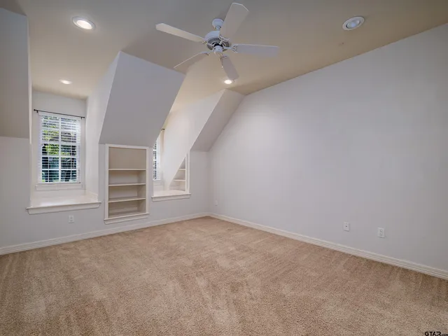 an empty room with windows and cabinet