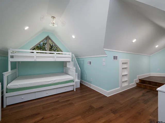 a view of room with wooden floor and cabinet