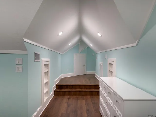 a bedroom with a bed and a view of kitchen