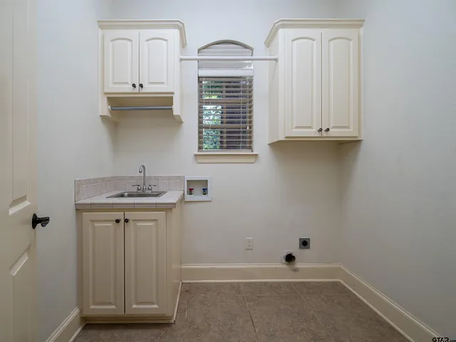 a bathroom with a sink a vanity and a window