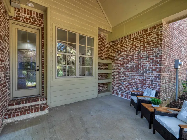 a view of a patio with table and chairs and a potted plant