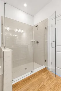 a bathroom with a shower and a glass door