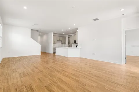 a view of a kitchen with a sink and a refrigerator