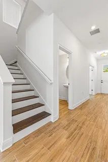 a view of a room with wooden floor and stairs