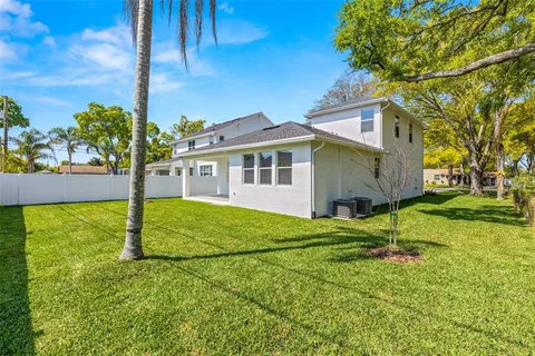 a house is sitting in middle od the grass