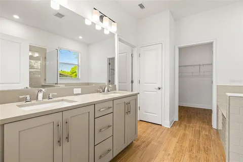 a bathroom with a double vanity sink and mirror