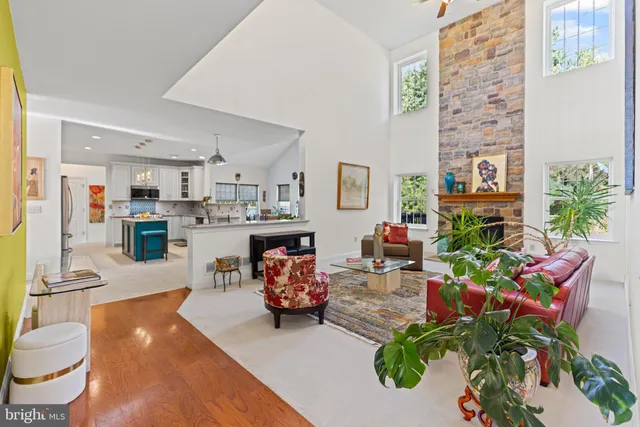 a living room with furniture and a kitchen view