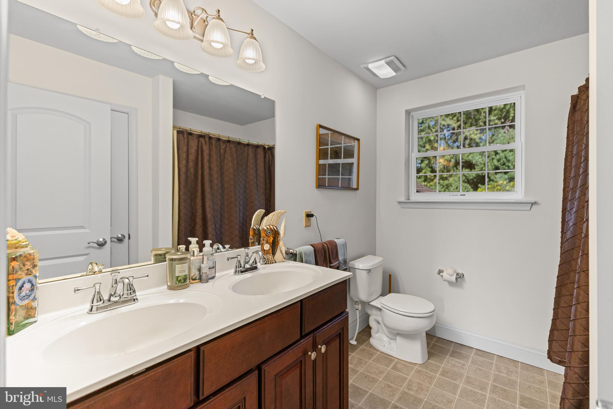 1 Cardinal Lane Sicklerville, NJ 08081 - Photo 24 of 35 a bathroom with a double vanity sink toilet and a mirror