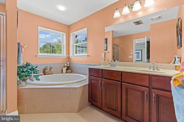 a bathroom with a tub shower and sink