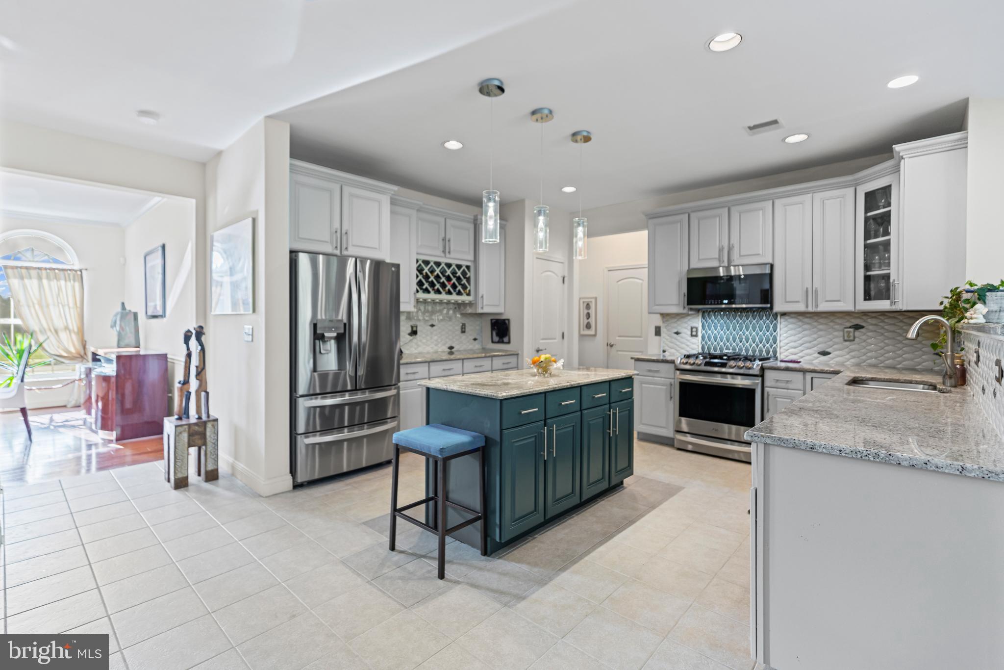 1 Cardinal Lane Sicklerville, NJ 08081 - Photo 10 of 35 a kitchen with stainless steel appliances kitchen island granite countertop a refrigerator and a stove top oven
