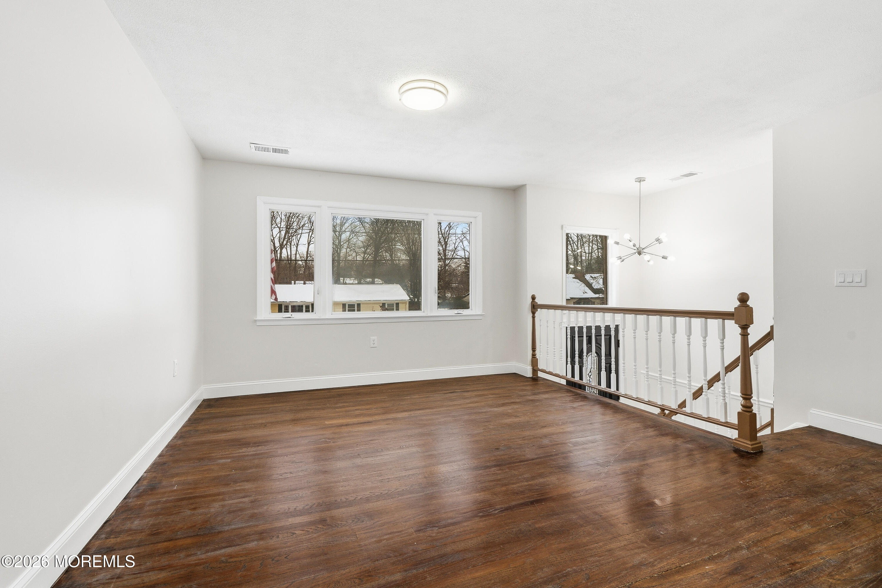 16 Crest Road Jackson, NJ 08527 - Photo 21 of 56 a view of an empty room with wooden floor and a window
