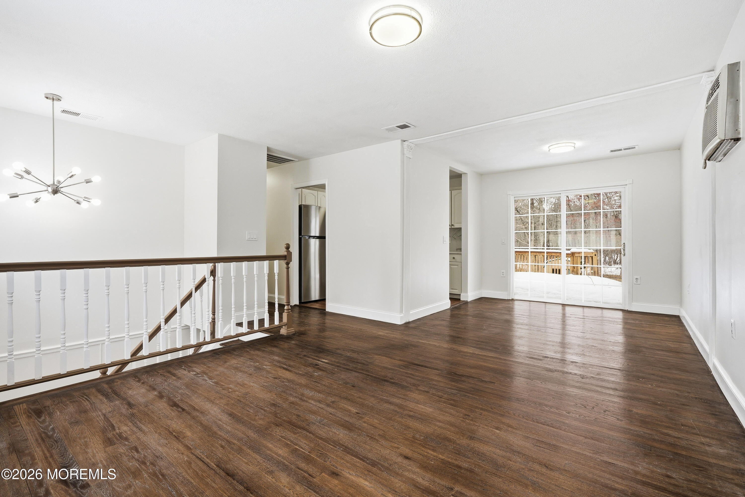 16 Crest Road Jackson, NJ 08527 - Photo 22 of 56 a view of an empty room with wooden floor and a window