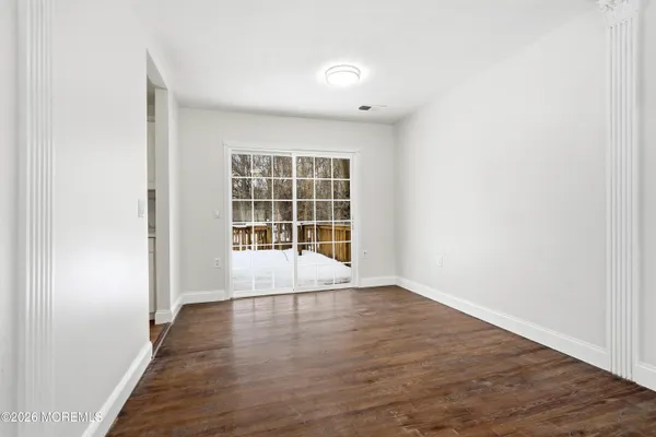 a view of a kitchen with wooden floor electronic appliances and window