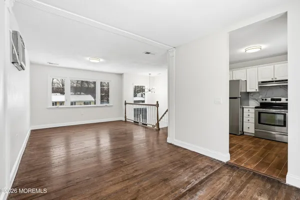 a kitchen with granite countertop white cabinets and stainless steel appliances