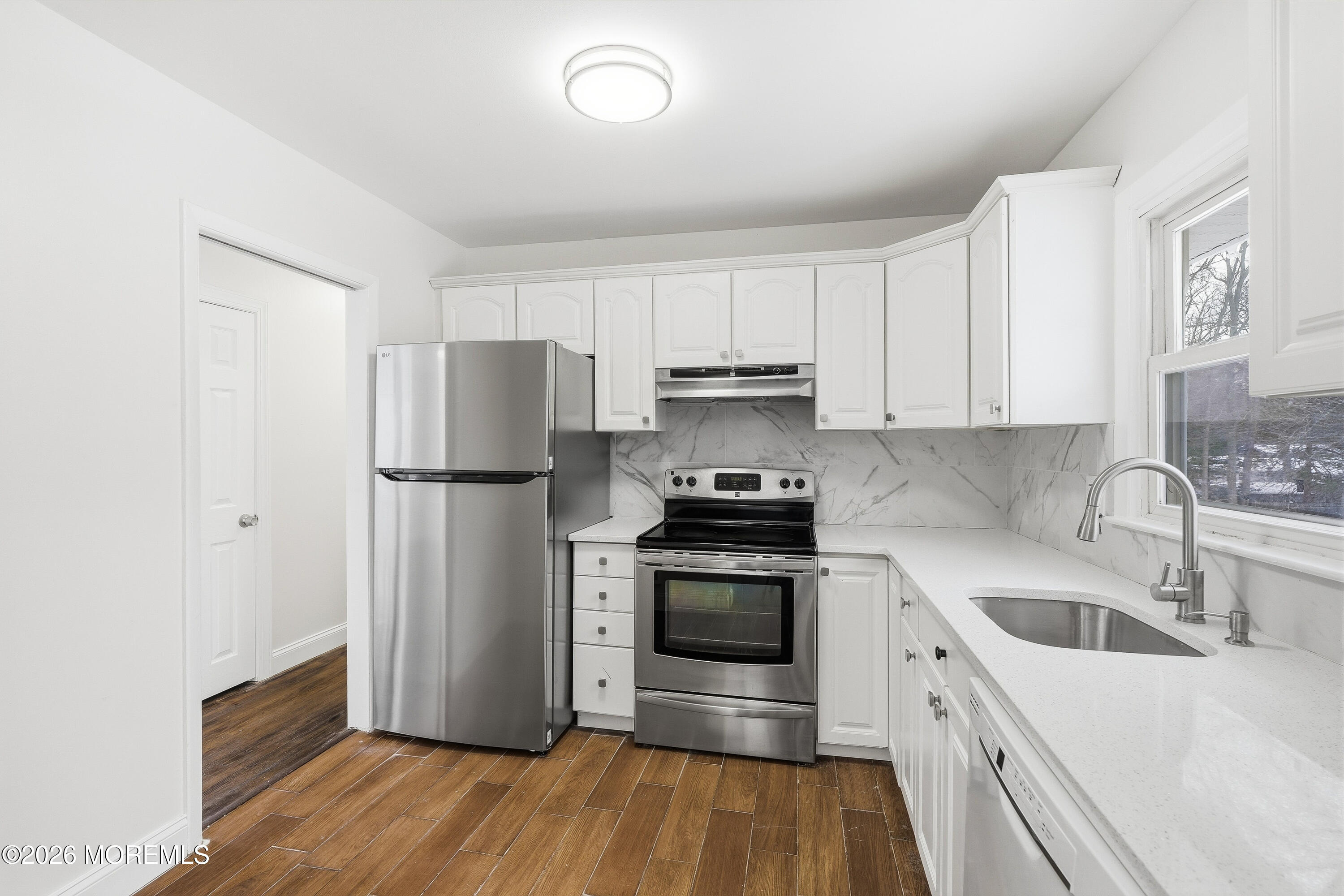 16 Crest Road Jackson, NJ 08527 - Photo 25 of 56 a kitchen with granite countertop white cabinets and stainless steel appliances