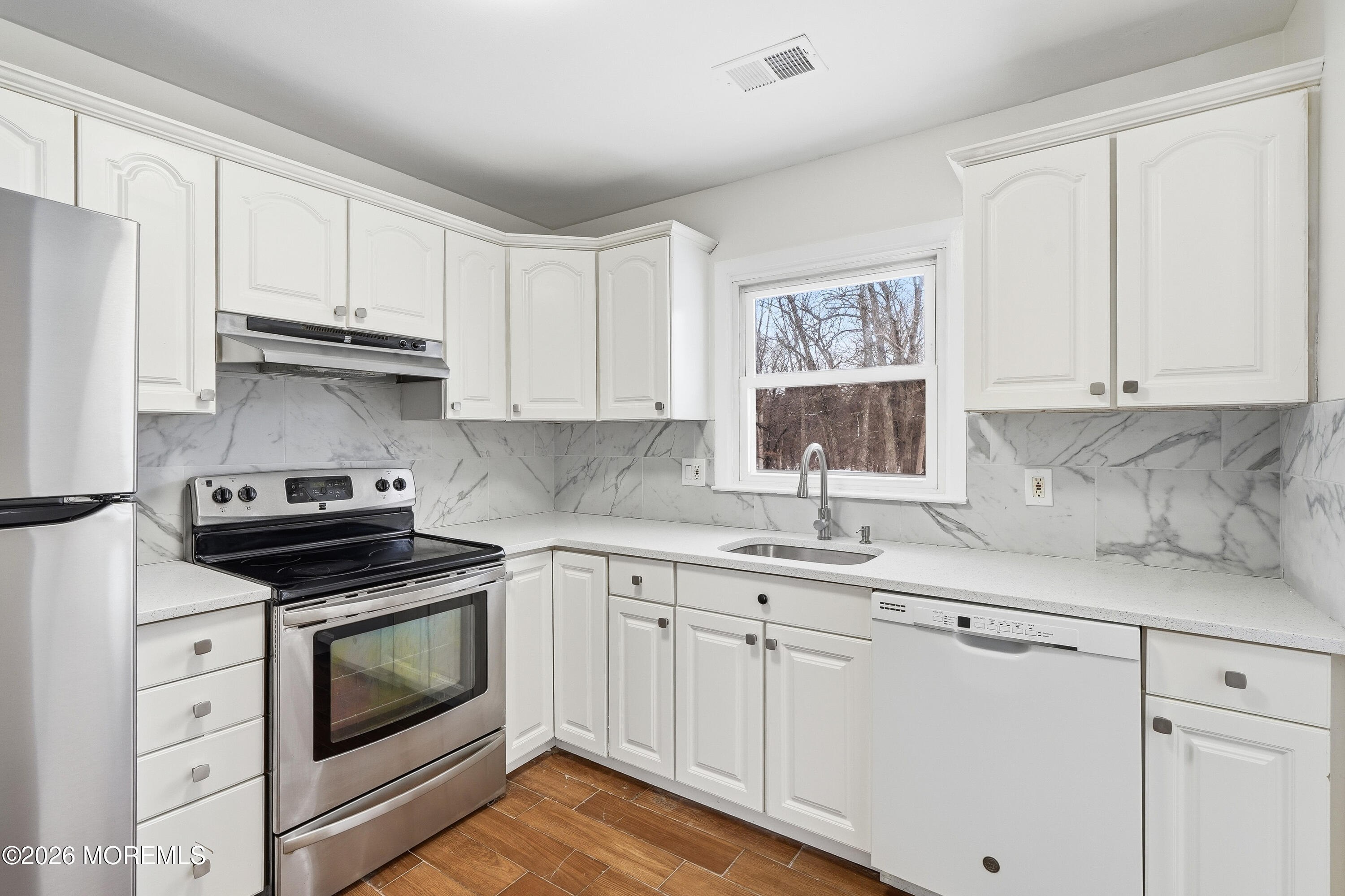 16 Crest Road Jackson, NJ 08527 - Photo 26 of 56 a kitchen with granite countertop white cabinets and white appliances