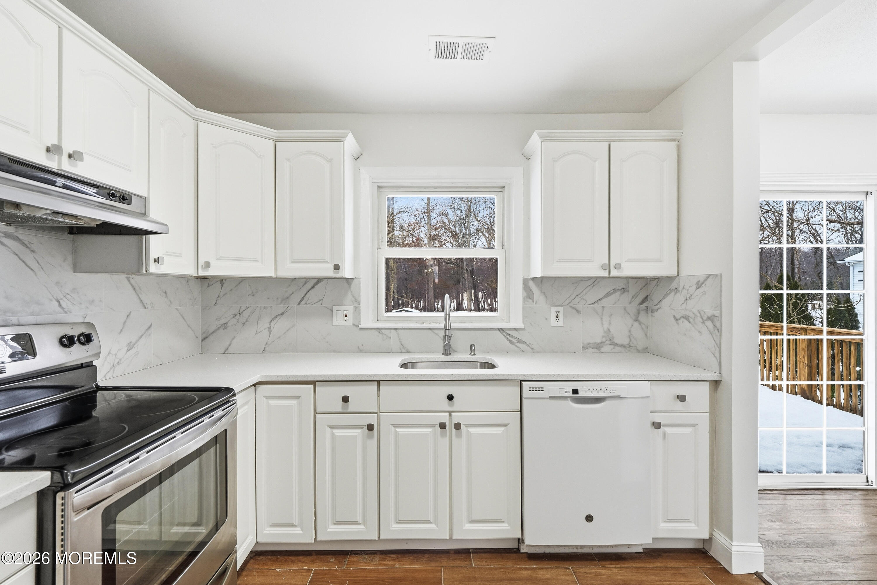 16 Crest Road Jackson, NJ 08527 - Photo 27 of 56 a kitchen with white cabinets and a stove top oven