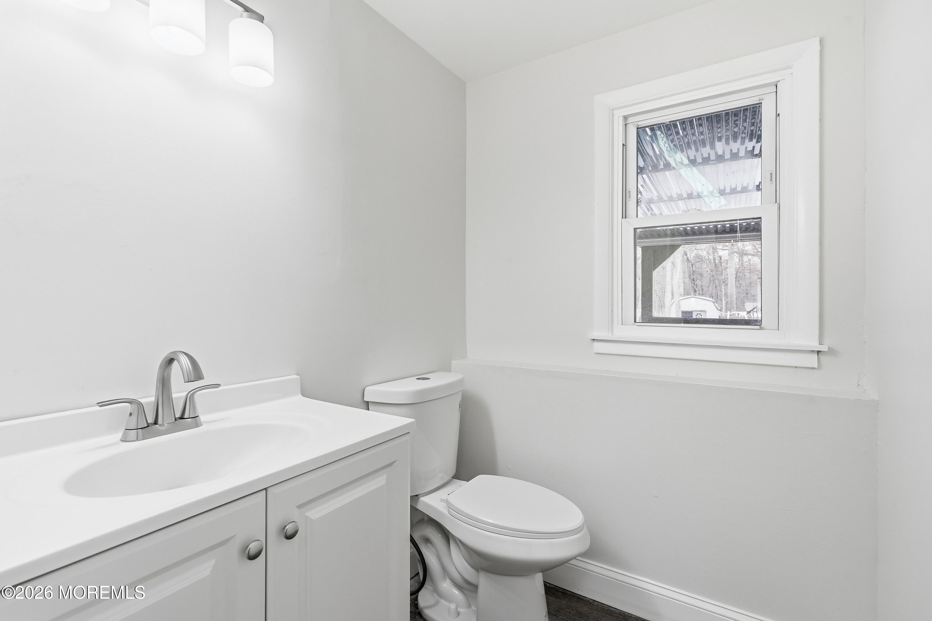 16 Crest Road Jackson, NJ 08527 - Photo 4 of 56 a bathroom with a toilet sink and mirror