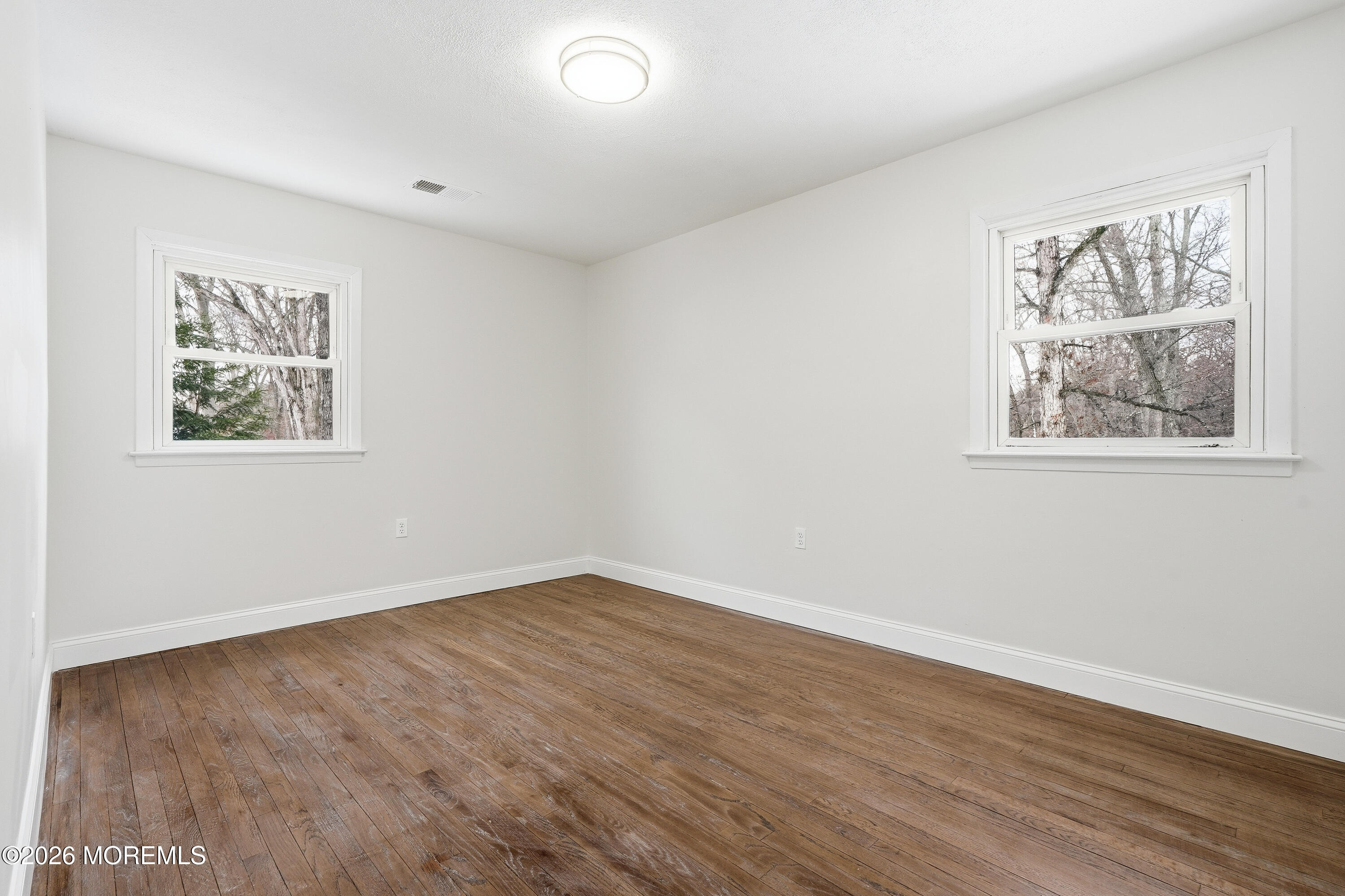 16 Crest Road Jackson, NJ 08527 - Photo 55 of 56 a view of an empty room with wooden floor and a window