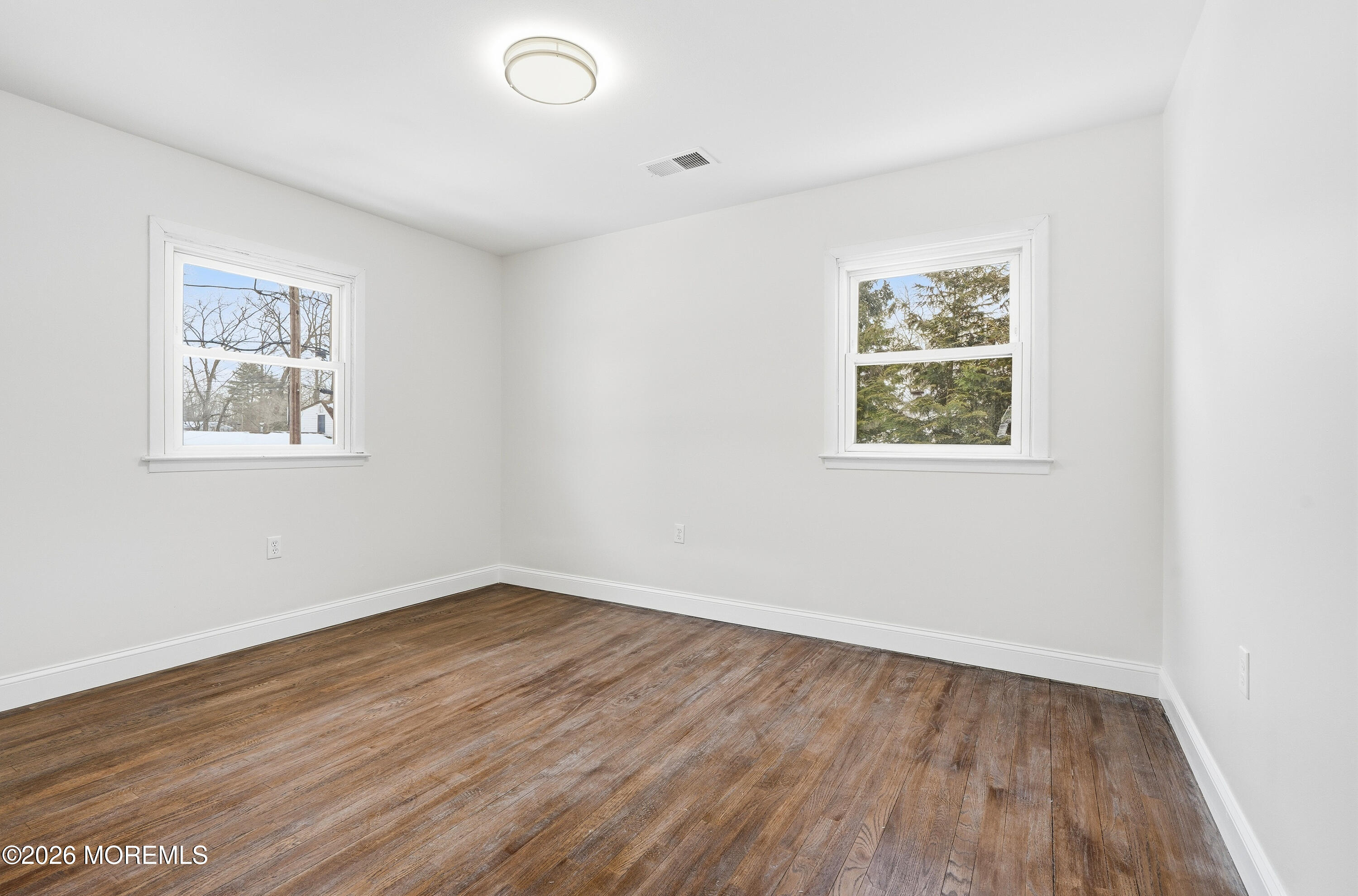 16 Crest Road Jackson, NJ 08527 - Photo 56 of 56 a view of an empty room with wooden floor and a window