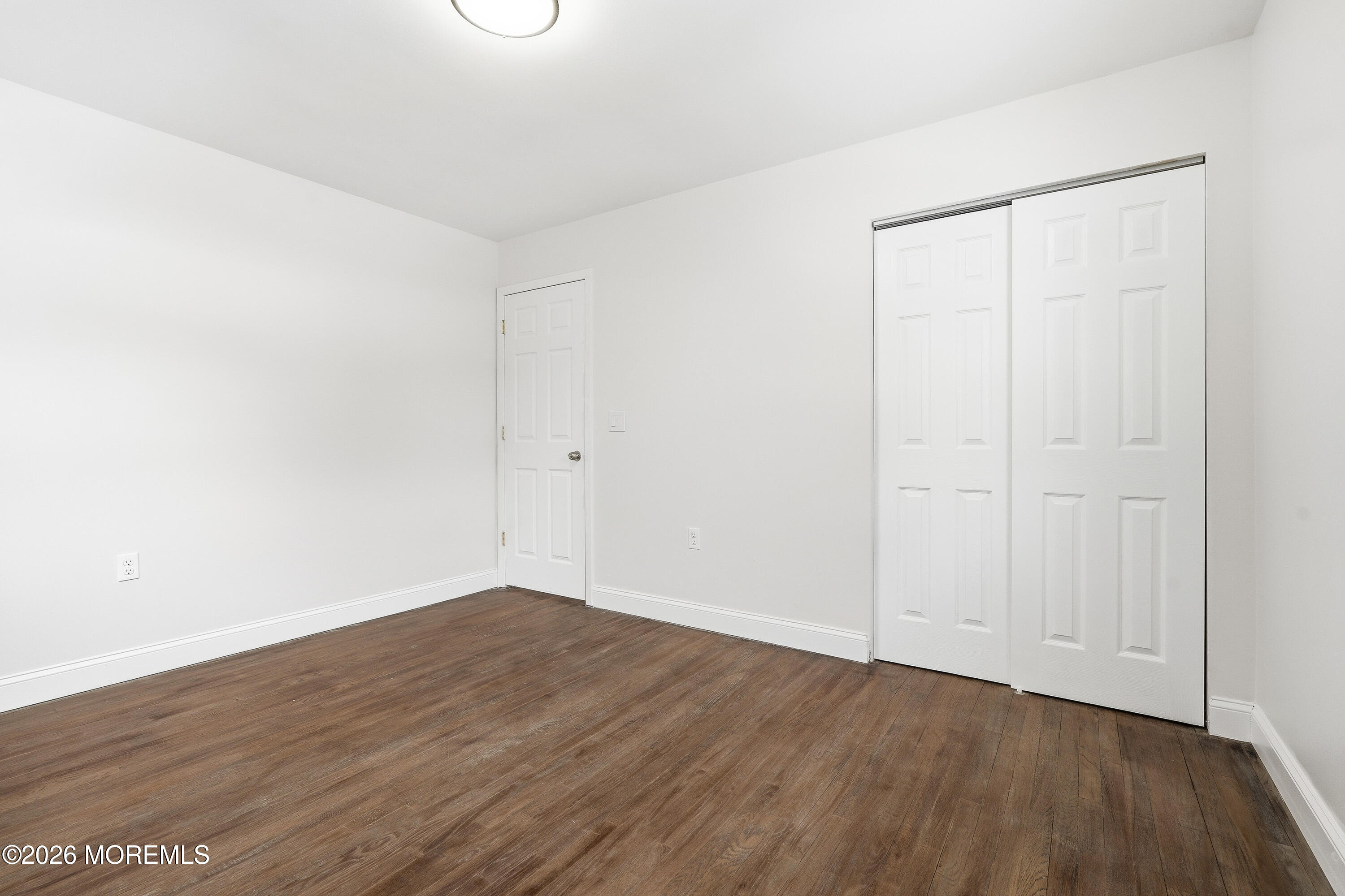 16 Crest Road Jackson, NJ 08527 - Photo 7 of 56 a view of an empty room with wooden floor