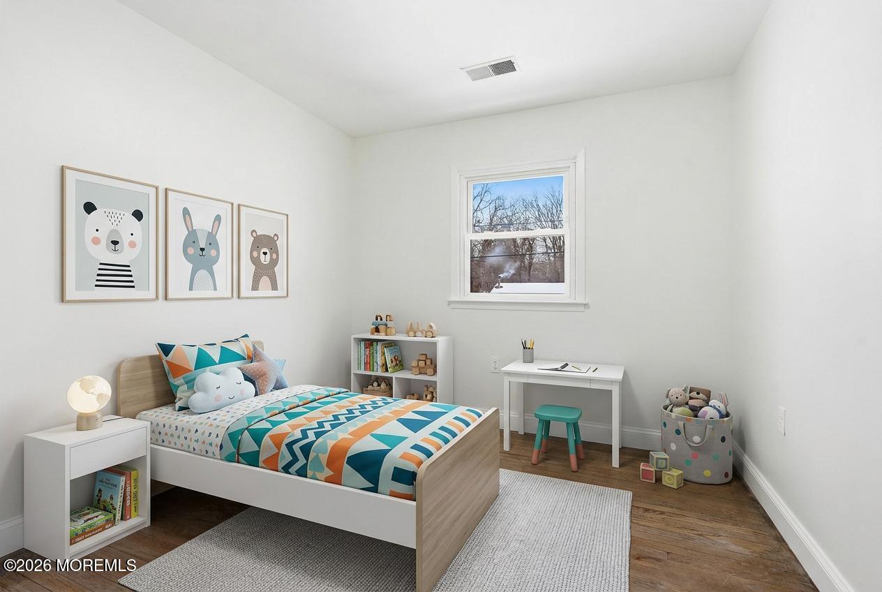 16 Crest Road Jackson, NJ 08527 - Photo 8 of 56 a bedroom with a bed and a table in it