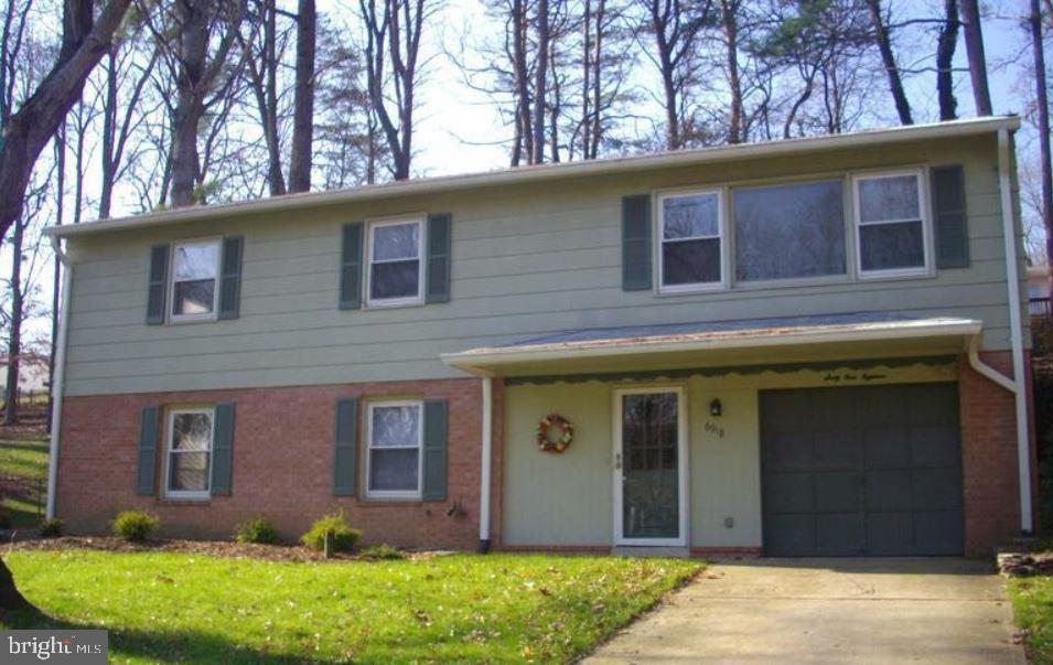 6918 Ashbury Drive Springfield, VA 22152 - Photo 1 of 9 a view of a house with a yard